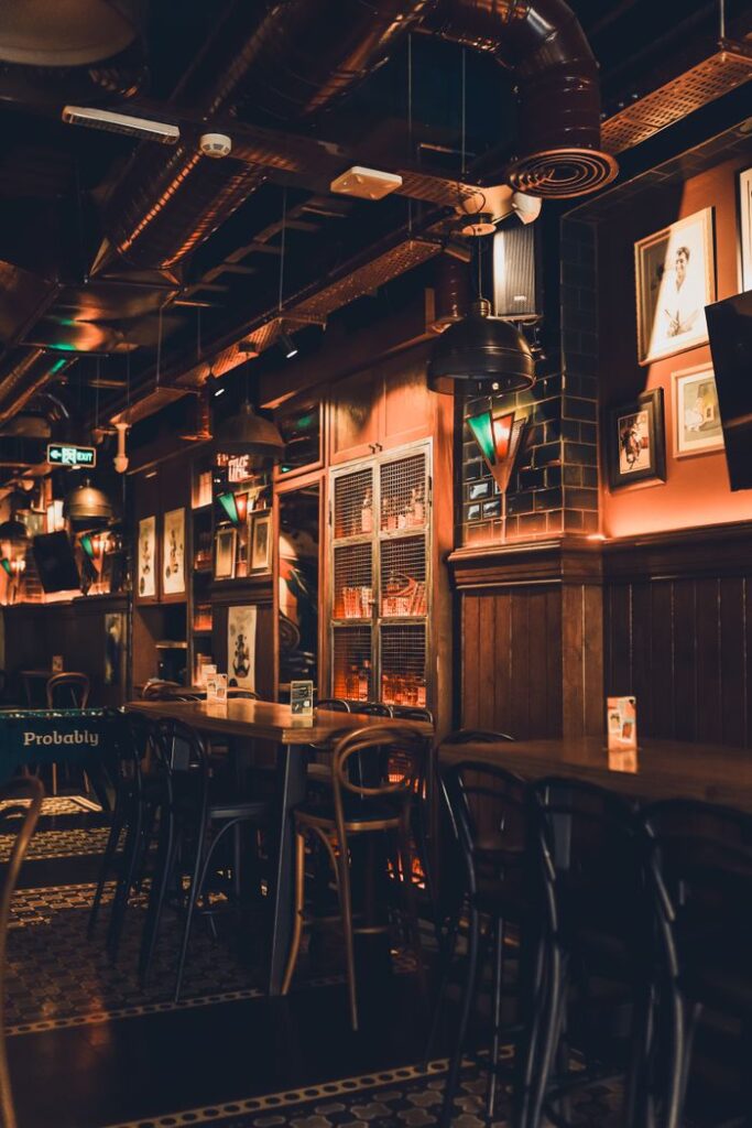 A charming vintage pub interior with dim lighting, creating a cozy atmosphere.