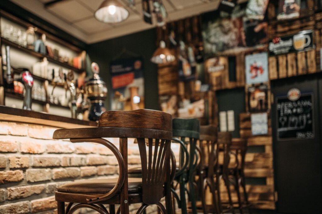 Warm, inviting pub interior featuring rustic wooden chairs in a laid-back setting.